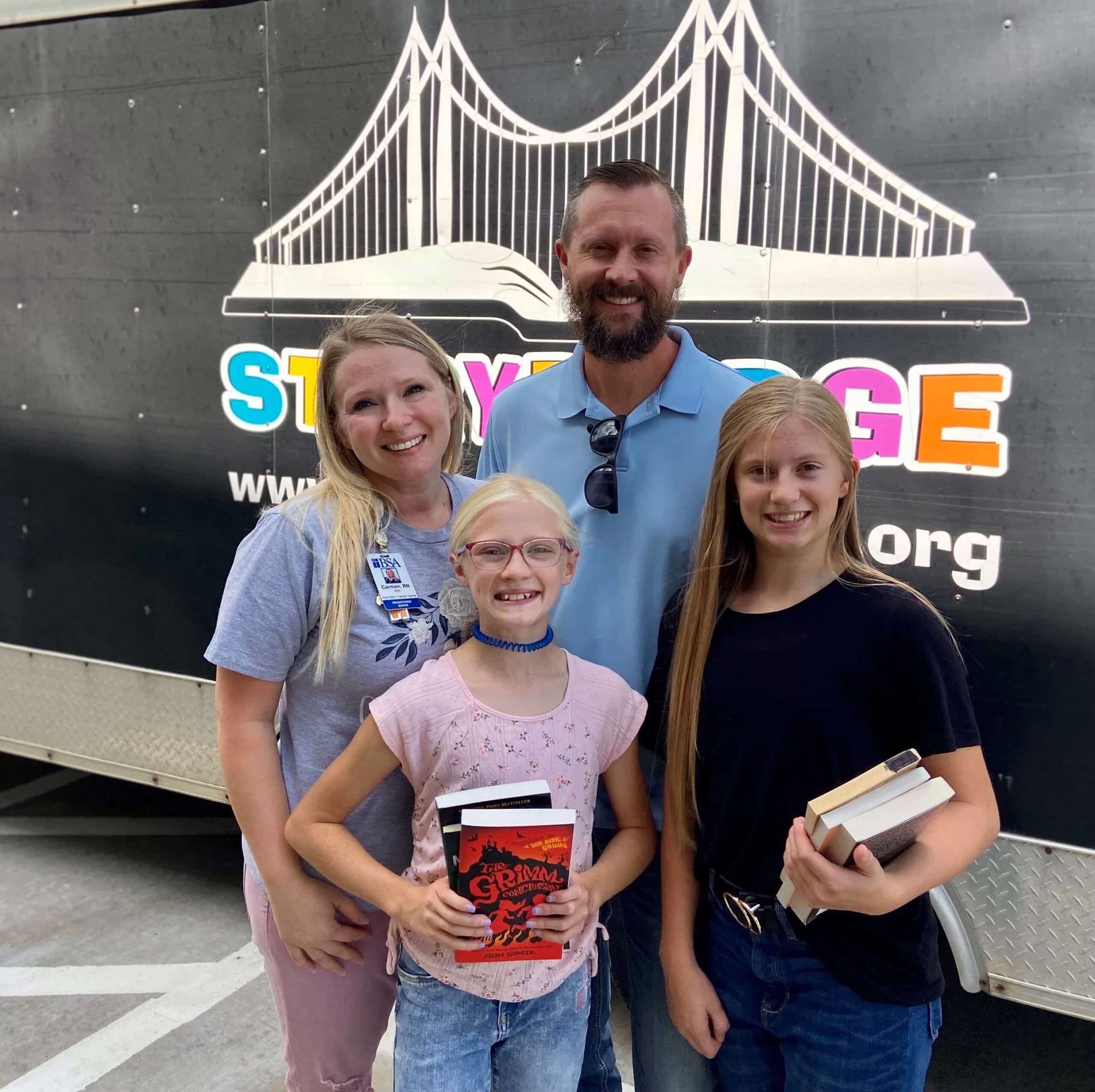 family holding books