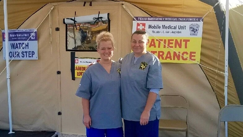 doctors in front of mobile medical unit tent