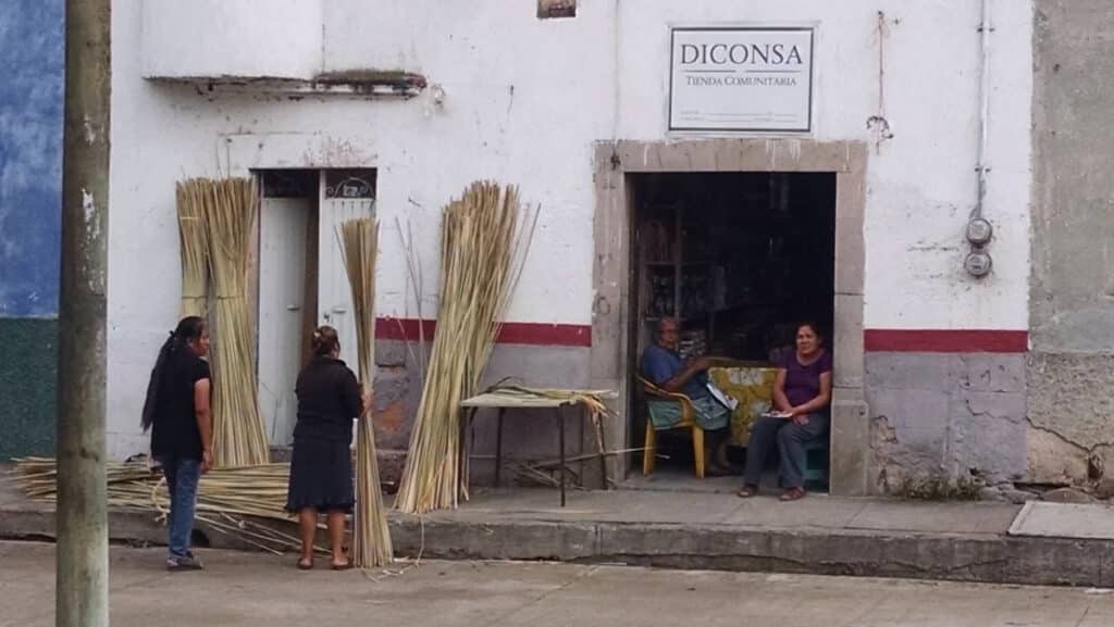 women collecting straw in street